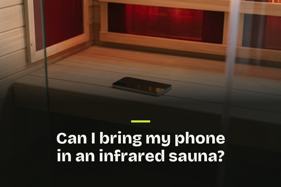Can I bring my phone in a infrared sauna The words "Can I bring my phone in an infrared sauna?" over a photo of a phone on a bench in an infrared sauna's red glow.