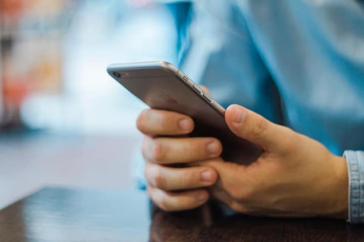 A close view of a hand holding a smartphone.