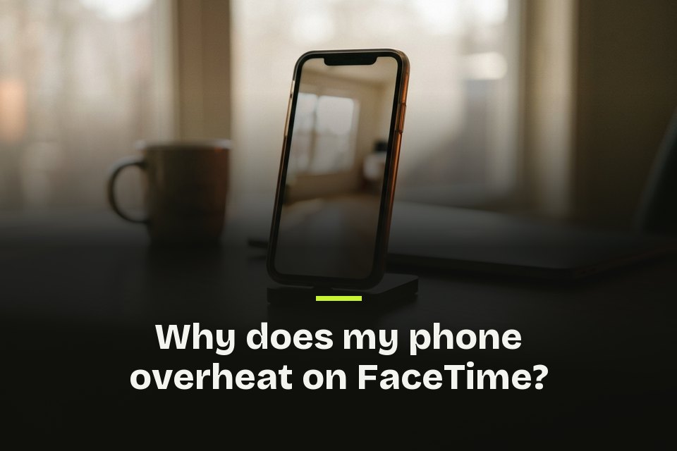 The words "Why does my phone overheat on FaceTime?" over a picture of a phone upright in a desk stand by a mug.